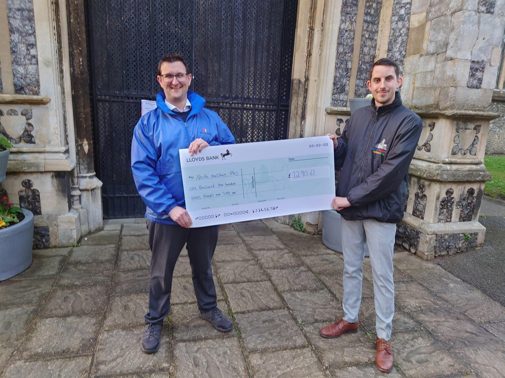 Children's Day Chairman Robert Murphy presenting cheque to Matthew Smith MBE, Trustee of North Walsham Play